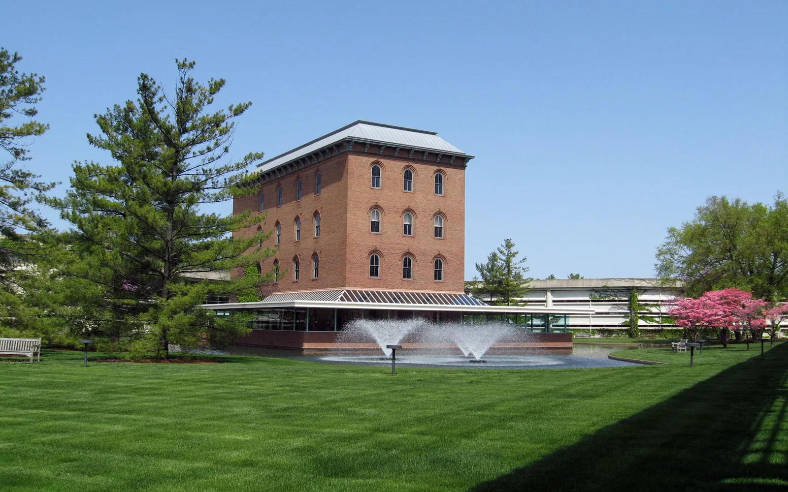 Modern corporate office building with glass and steel facade, professional business park setting